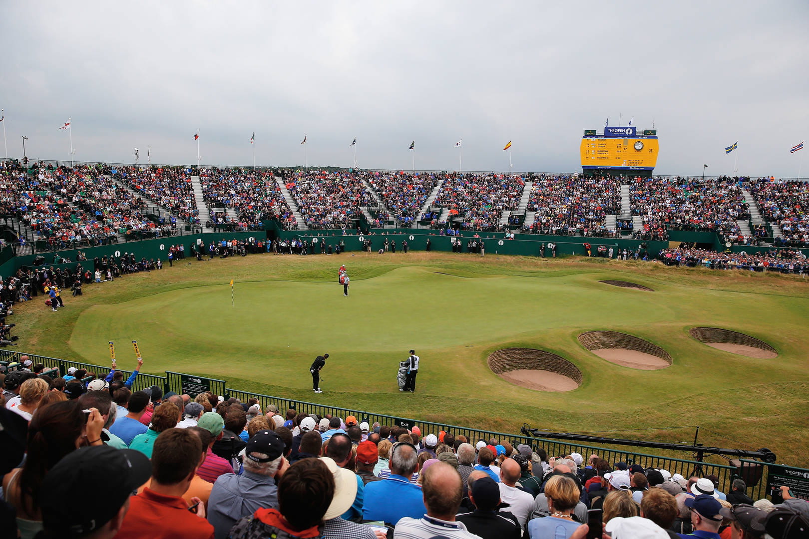 Spectators enjoy the action from the stands surrounding the 18th green at Royal Liverpool in 2014